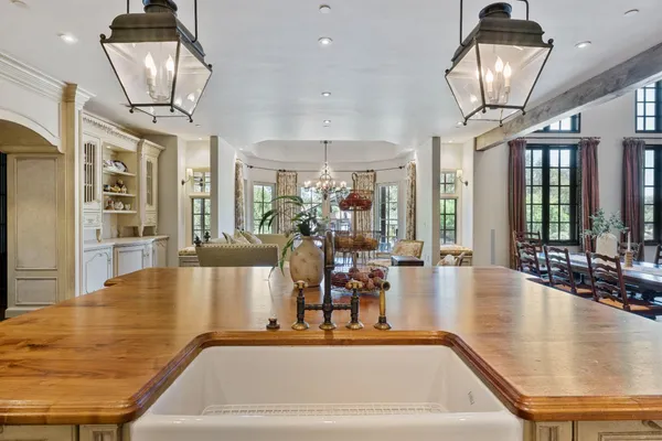 a hallway with white doors wooden floor and front door