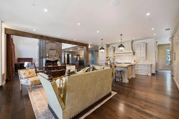 a view of a a dining room with furniture window and wooden floor