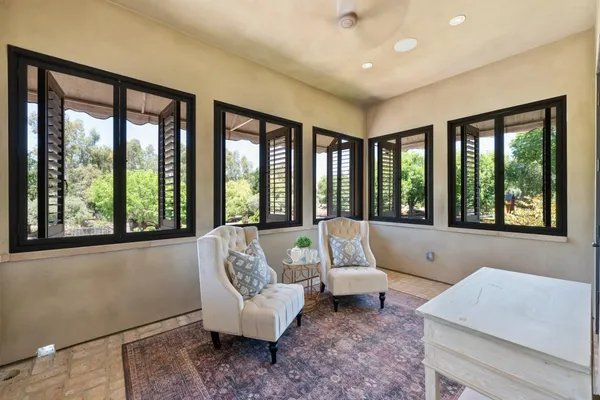a view of a patio with a table chairs and a backyard