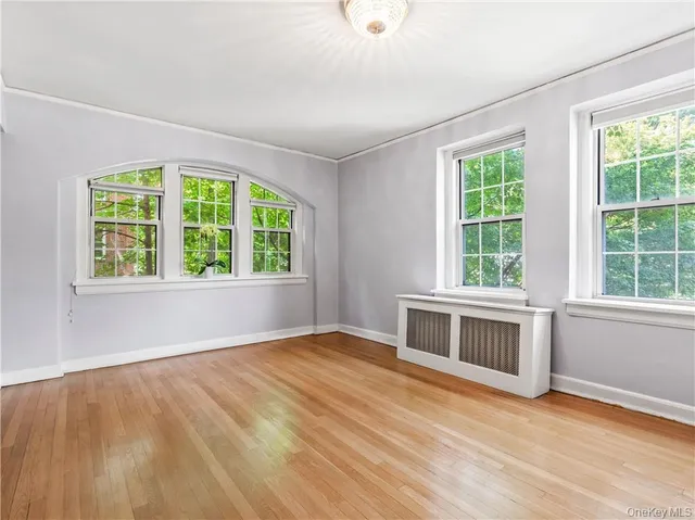 a bedroom with a large bed and a large window