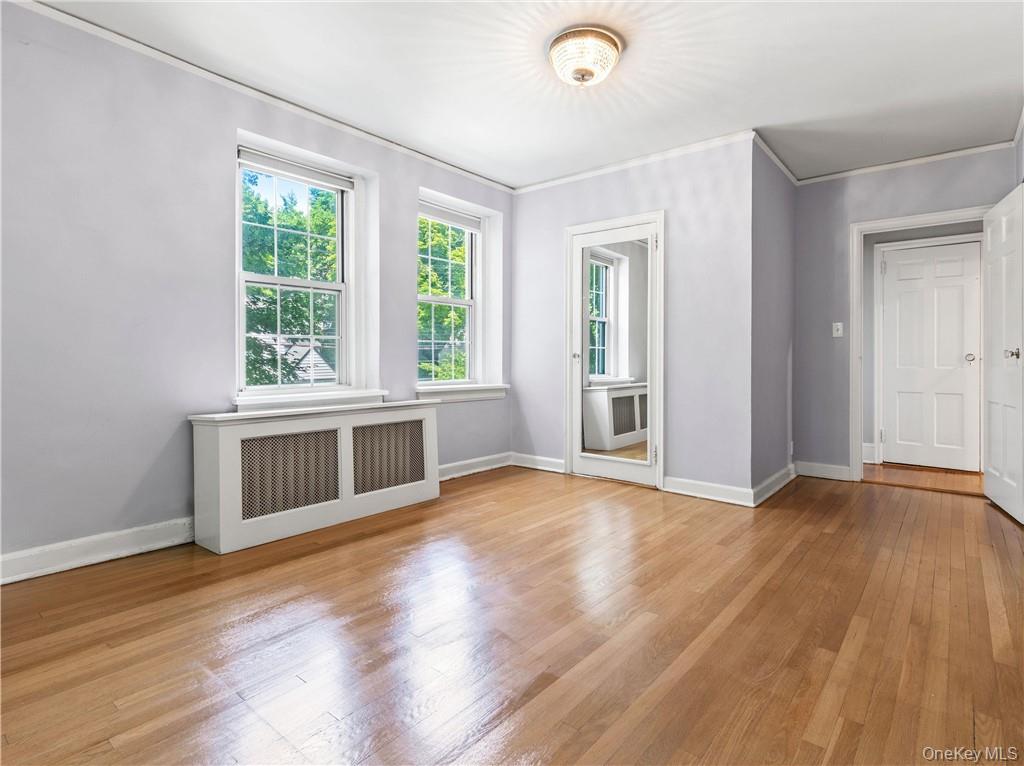 270 Bronxville Road, Unit B43 Bronxville, NY 10708 - Photo 21 of 36 an empty room with wooden floor and windows