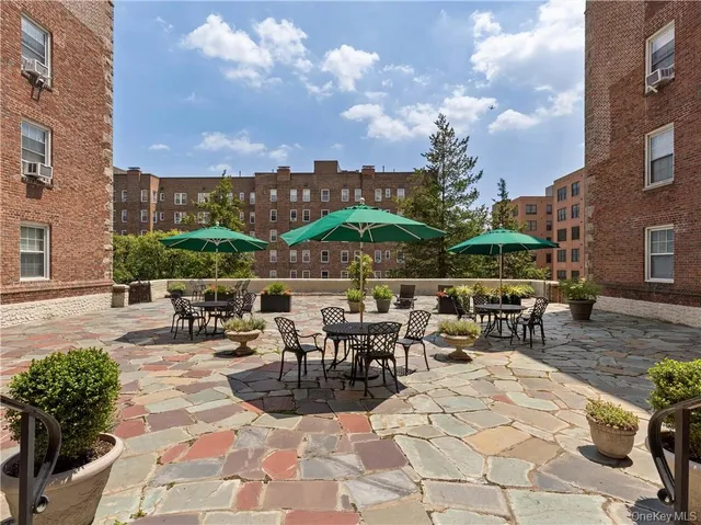 a view of a patio with a table and chairs