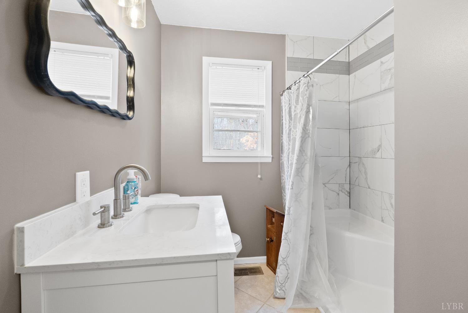 969 Hawkins Road Evington, VA 24550 - Photo 12 of 40 a bathroom with a sink toilet and shower