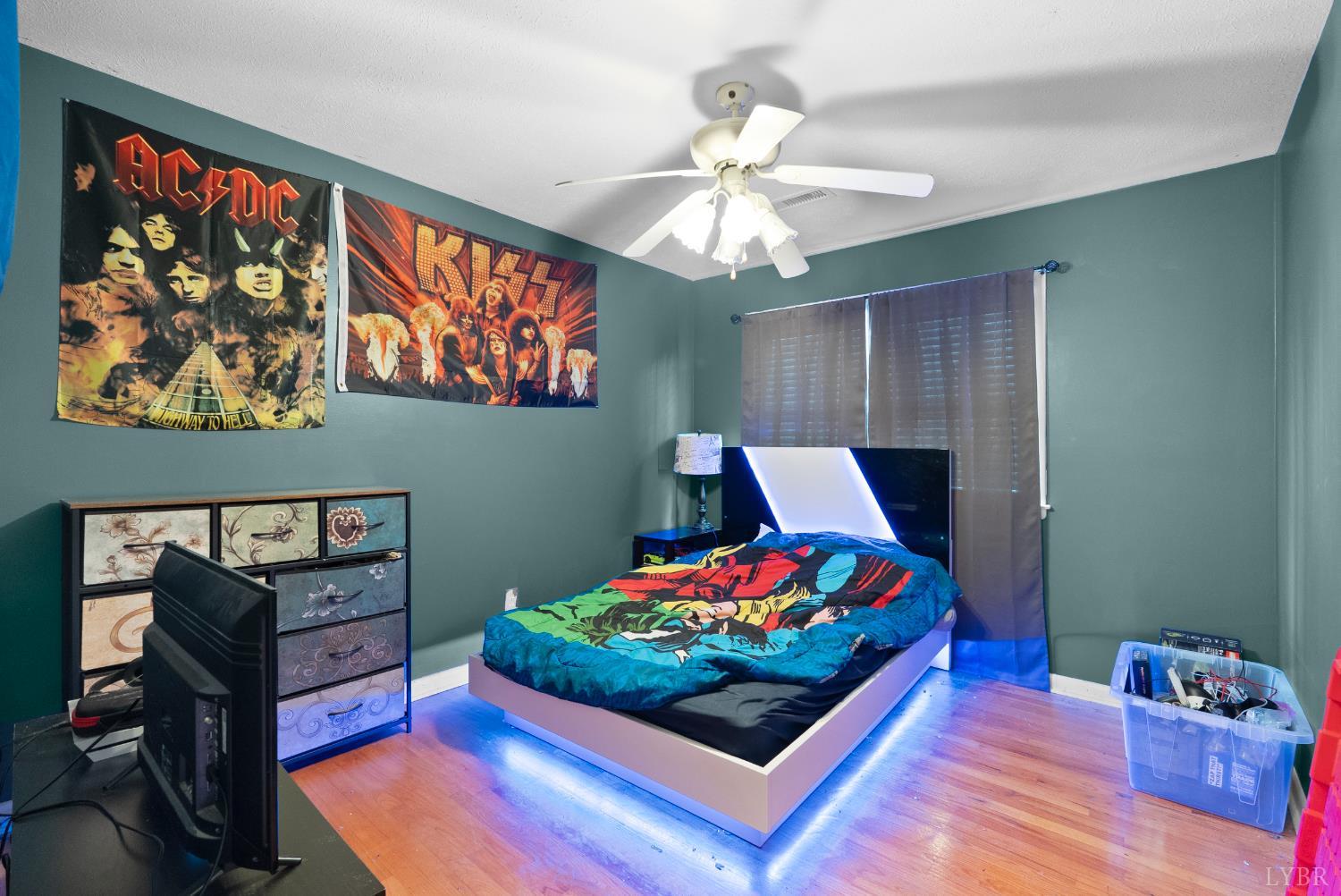 969 Hawkins Road Evington, VA 24550 - Photo 13 of 40 a bedroom with a bed and wooden floor