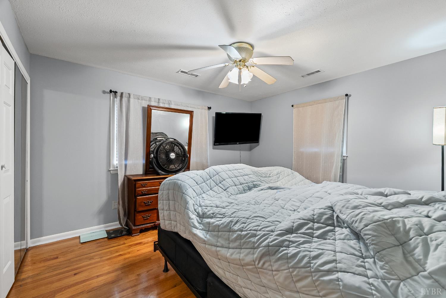 969 Hawkins Road Evington, VA 24550 - Photo 14 of 40 a bedroom with a bed and wooden floor