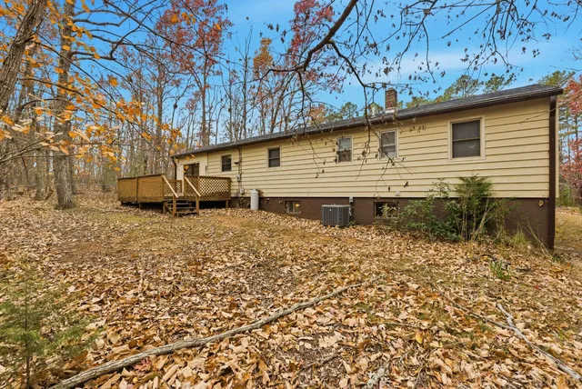 a backyard of a house with table and chairs