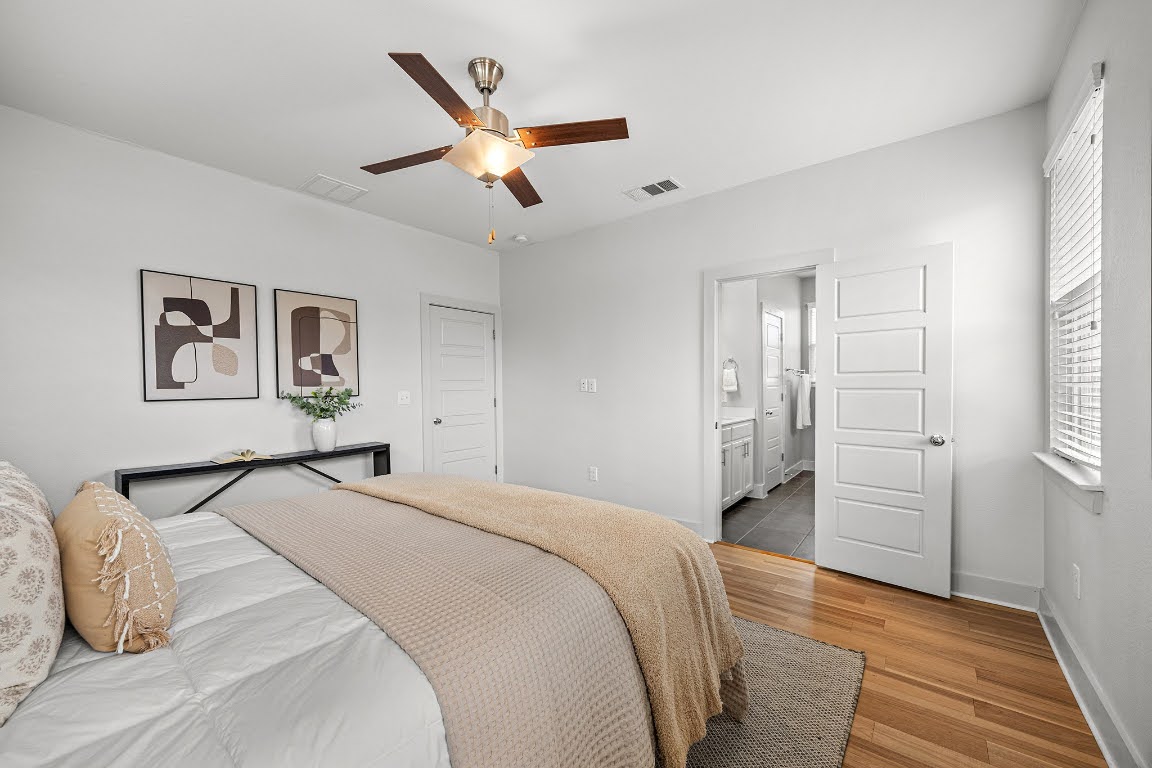 2315 Capulet Street Austin, TX 78741 - Photo 17 of 33 a bedroom with a large bed and a chandelier