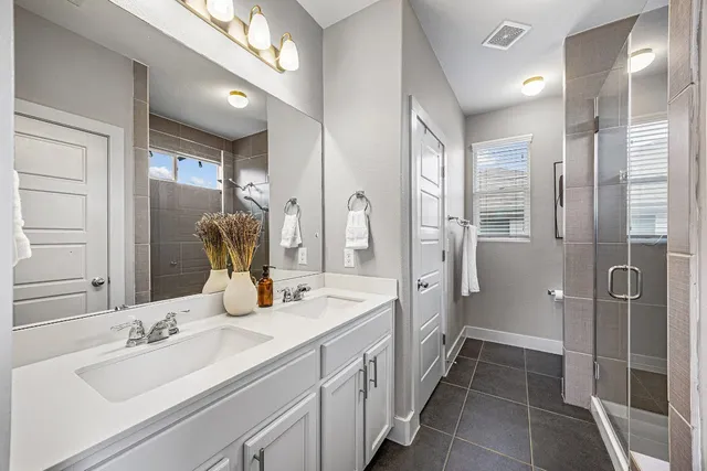 a bathroom with a double vanity sink mirror and double