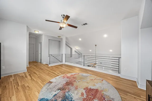 a large bedroom with a bed and a chandelier