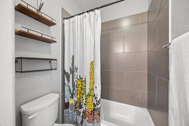 a bathroom with a shower and a toilet