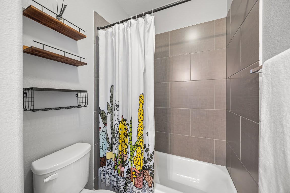 2315 Capulet Street Austin, TX 78741 - Photo 24 of 33 a bathroom with a shower and a toilet