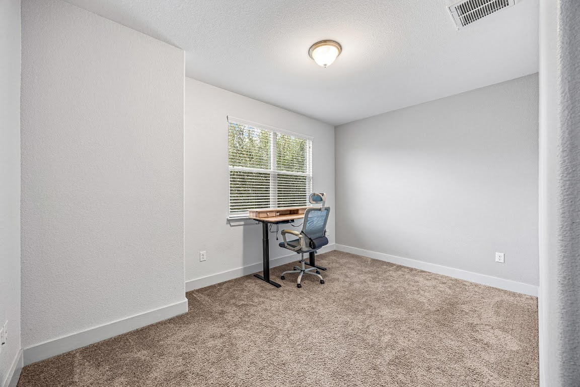 2315 Capulet Street Austin, TX 78741 - Photo 25 of 33 a workspace with furniture and a window