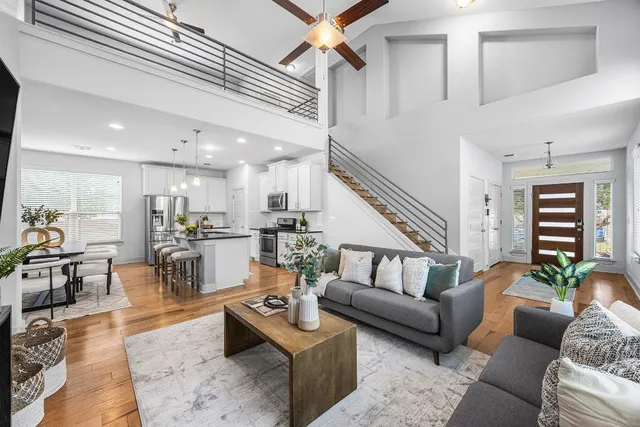 a living room with furniture kitchen view and a table