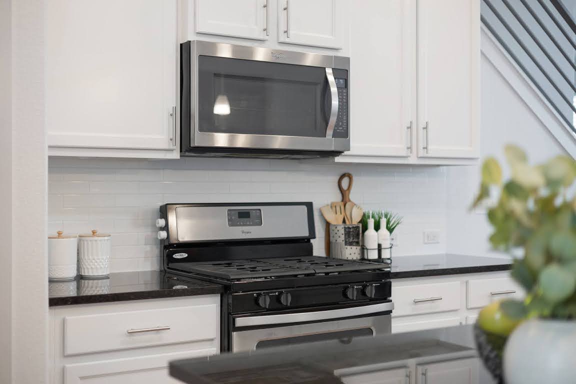 2315 Capulet Street Austin, TX 78741 - Photo 7 of 33 a kitchen with stainless steel appliances granite countertop a stove and a microwave