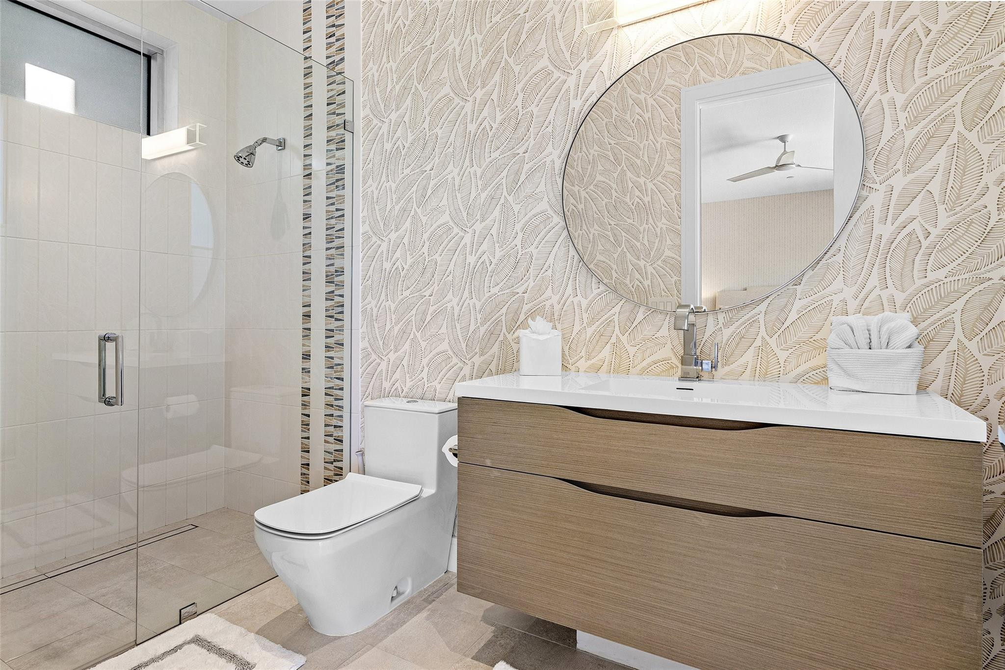 1022 Langer Way Delray Beach, FL 33483 - Photo 17 of 38 a bathroom with a toilet sink and mirror