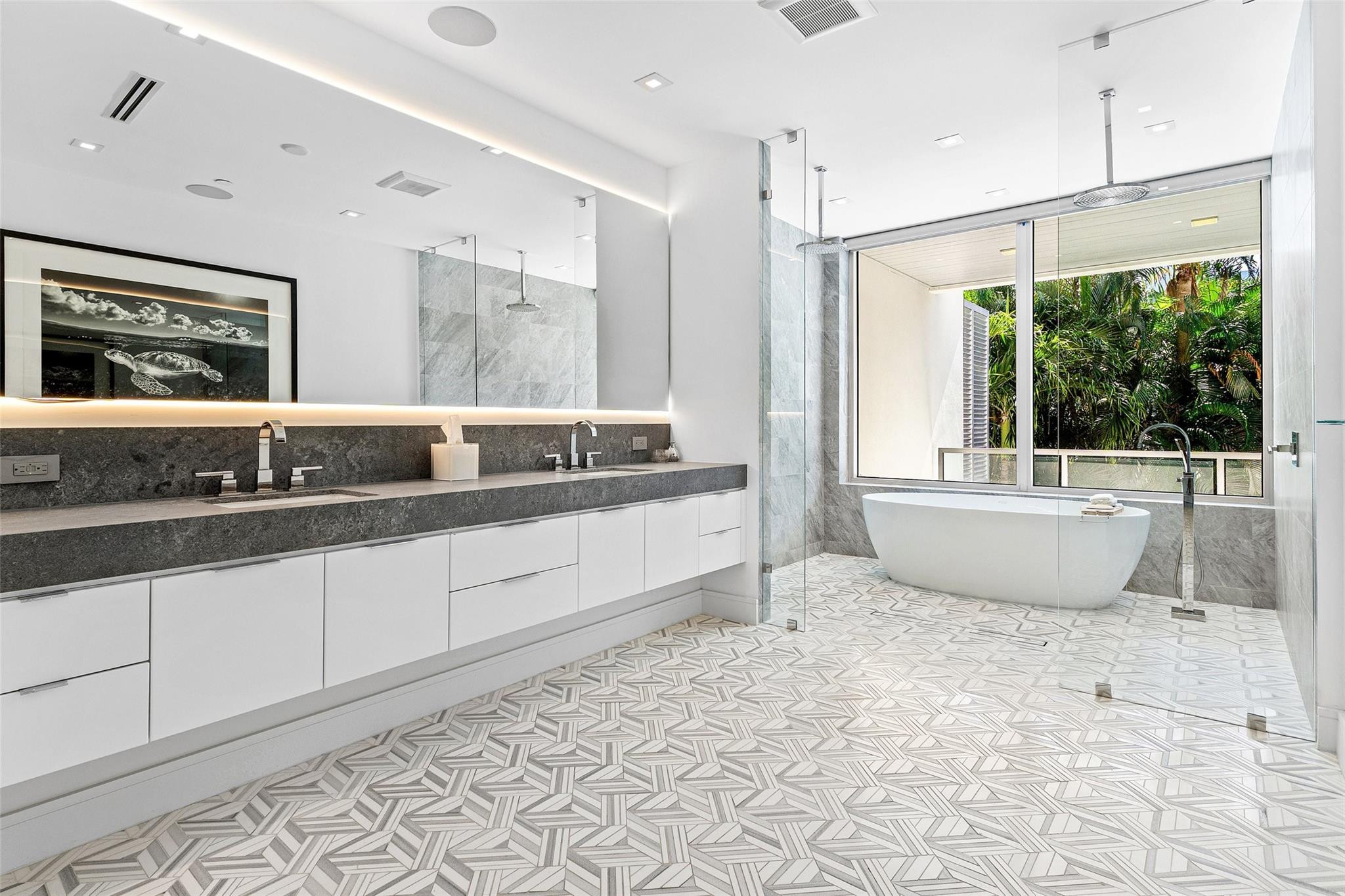 1022 Langer Way Delray Beach, FL 33483 - Photo 21 of 38 a bathroom with a double vanity sink a mirror and a bathtub