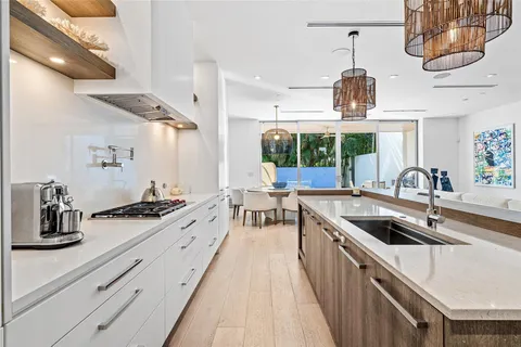 a kitchen with stainless steel appliances a sink a stove and cabinets