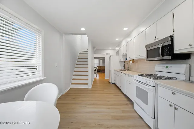 a bathroom with a granite countertop sink a toilet and shower