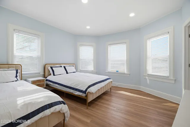 a bathroom with a bathtub a sink a toilet and a window