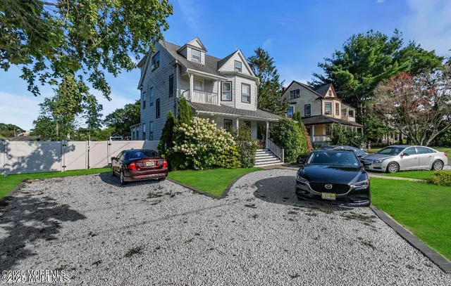 a view of a chair and table in backyard of the house