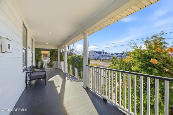 a view of a balcony with chair and flower pot