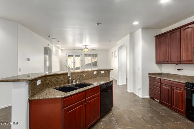 a kitchen with granite countertop stainless steel appliances and wooden cabinets