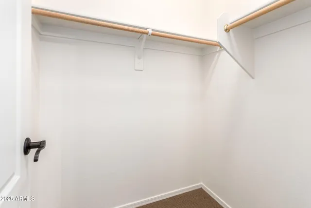 an empty room with chandelier fan