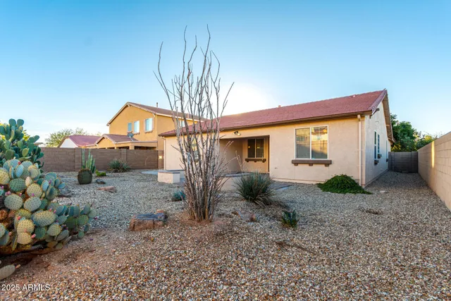 a backyard of a house with table and chairs