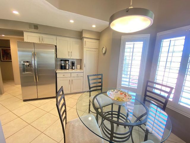 a kitchen with stainless steel appliances granite countertop a refrigerator a stove a sink dishwasher and a refrigerator