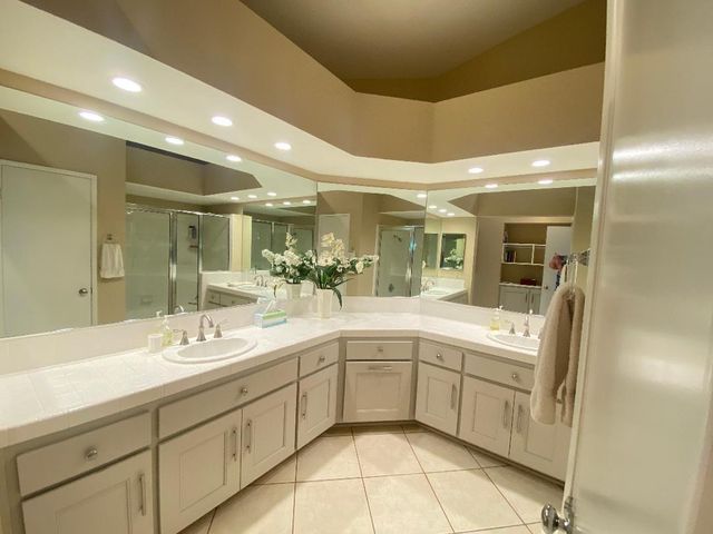 a spacious bathroom with a sink mirror and