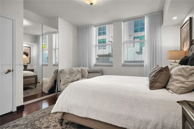 a bedroom with a bed and glass door