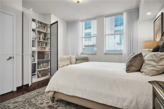 a bedroom with a large bed and a window