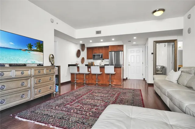 a living room with furniture and a rug