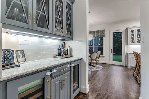 a kitchen with stainless steel appliances granite countertop a coffee maker on granite countertops and cabinets