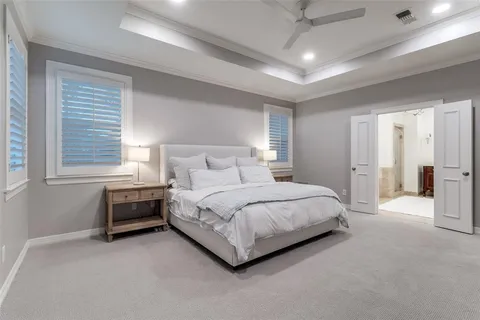 a spacious bedroom with a bed and a window