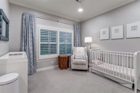 a bedroom with furniture and a large window
