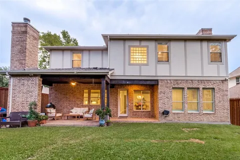 a view of a house with a yard and sitting area