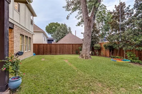 a view of a house with a yard and a garden