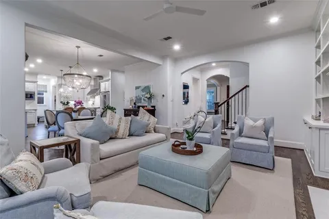 a living room with furniture kitchen and a chandelier