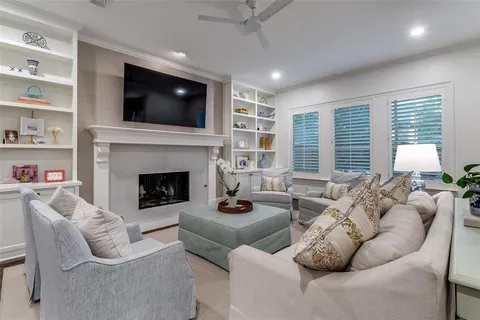 a living room with furniture a flat screen tv and a fireplace