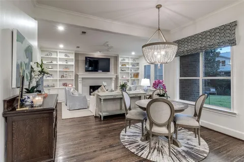 a living room with furniture a flat screen tv and kitchen view
