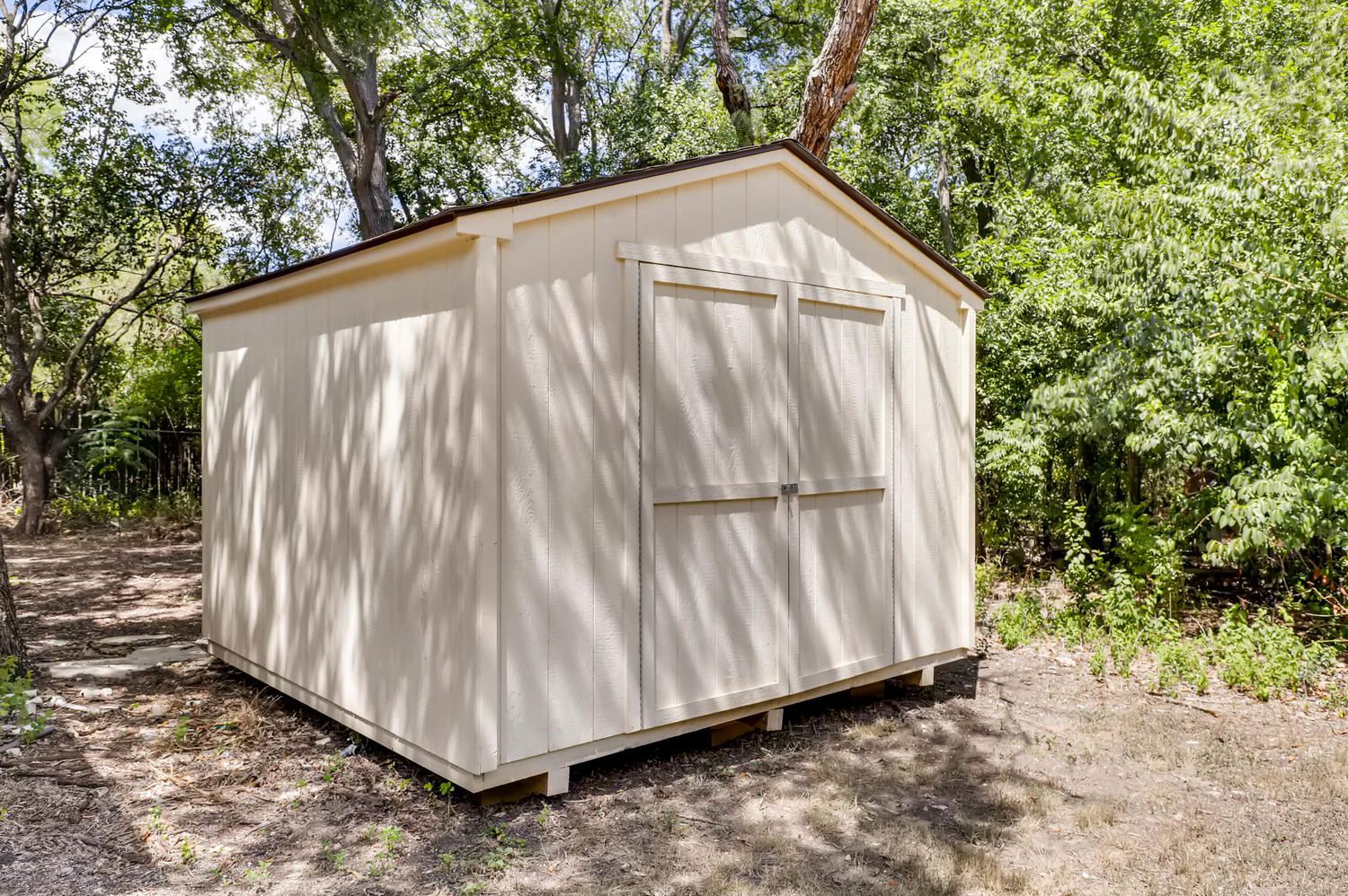 446 Pike Road San Antonio, TX 78209 - Photo 28 of 28 A versatile storage shed provides ample space for tools and outdoor equipment amidst lush greenery.