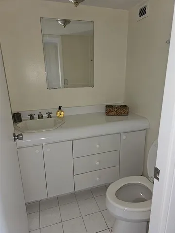a bathroom with a sink toilet and mirror