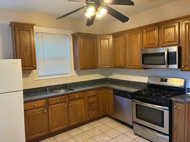 a kitchen with stainless steel appliances granite countertop a stove and a microwave
