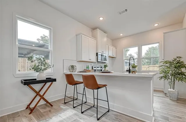 a bathroom with a double vanity sink toilet and shower