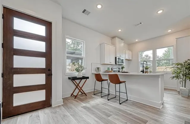 a kitchen with stainless steel appliances granite countertop a stove and a sink