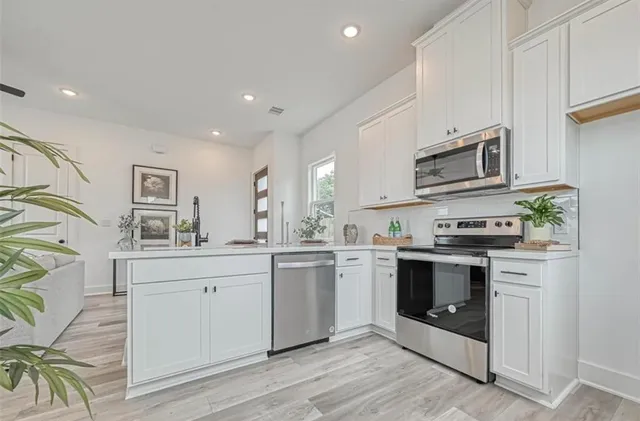a living room with kitchen island furniture and wooden floor