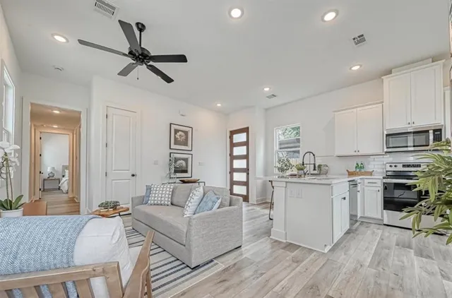 a bedroom with a bed and painting on the wall
