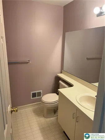 a white toilet sitting next to a bathroom sink