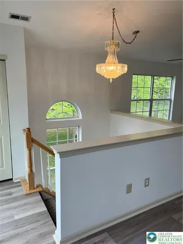 a view of a hallway with a chandelier